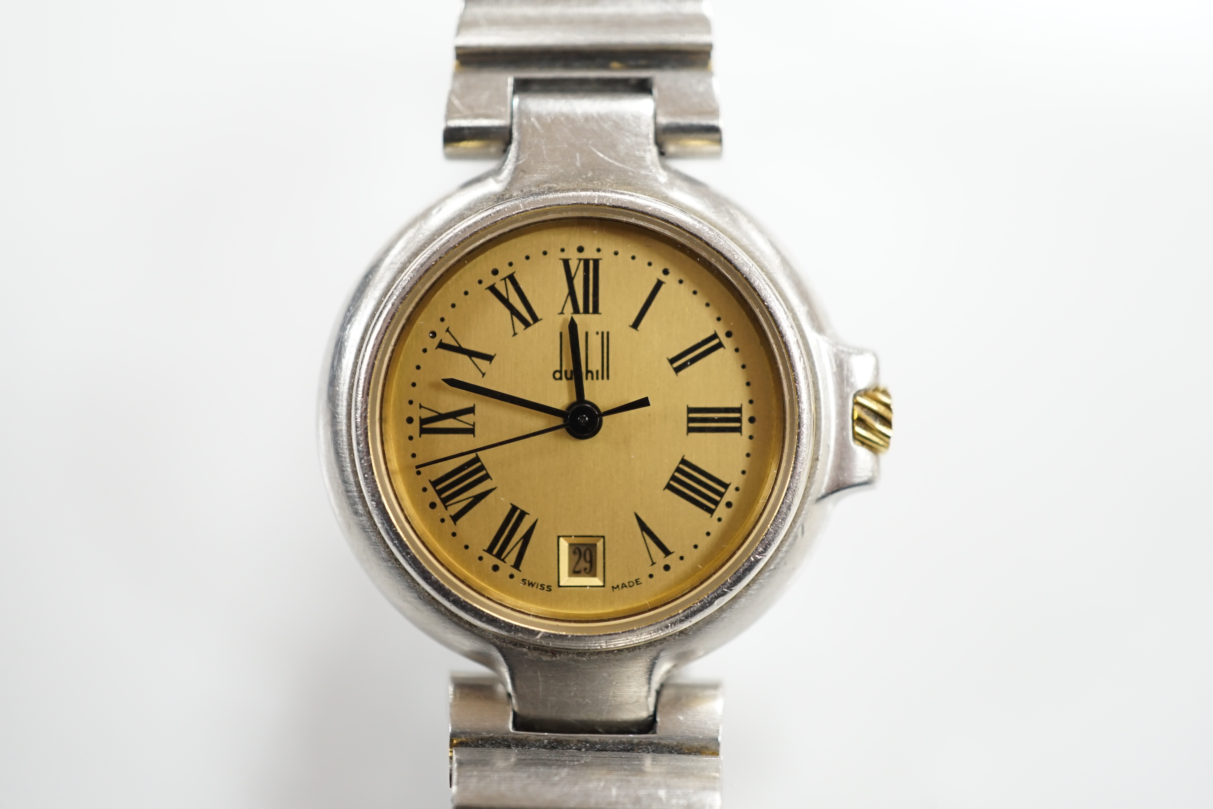A lady's 1970's stainless steel Dunhill quartz wrist watch, with centre seconds and date aperture with box and papers.